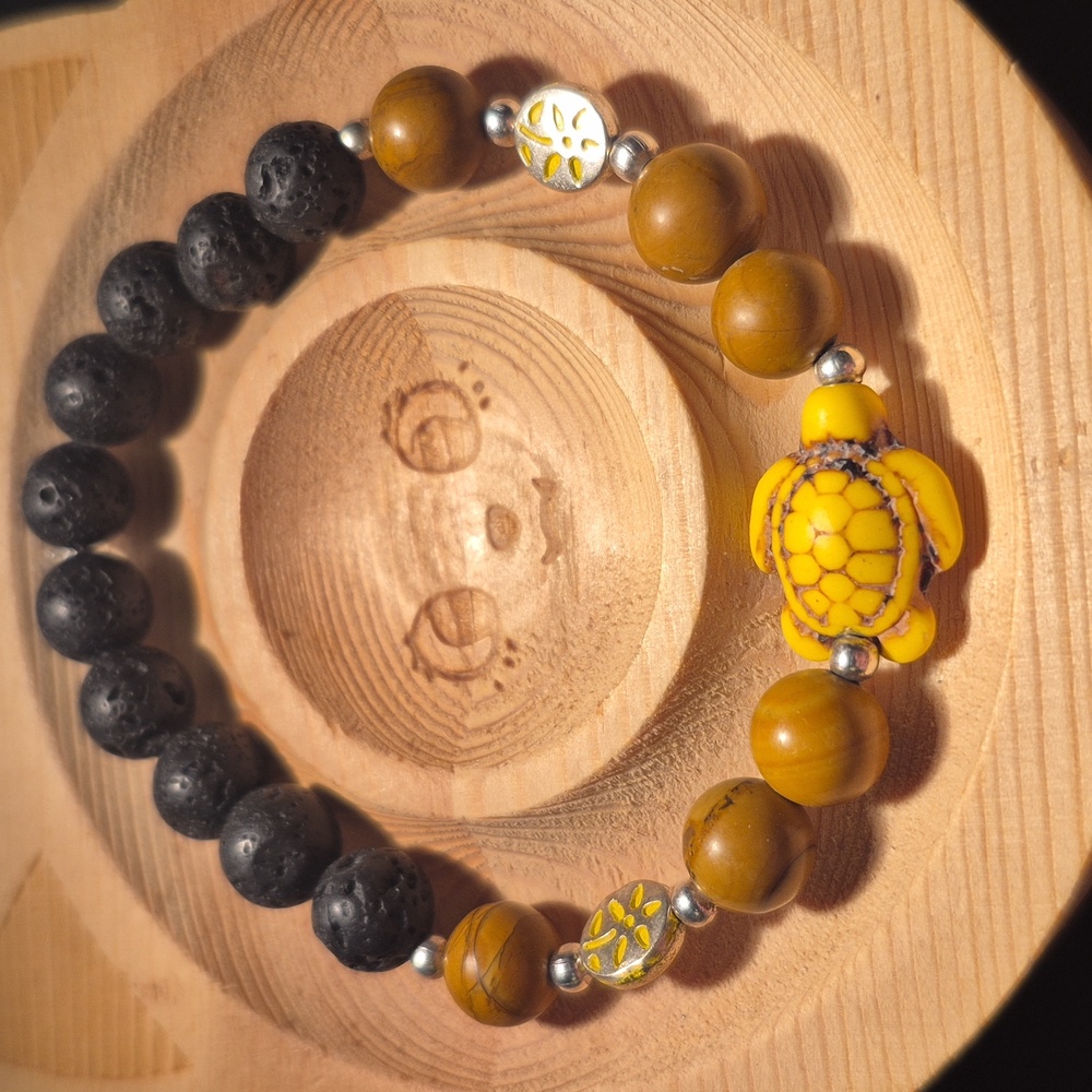 Petrified wood with yellow turtle and lava beads